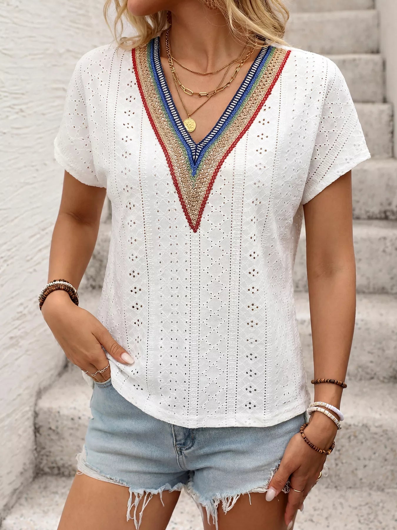 Cedar & Moore Eyelet V-Neck Short Sleeve Top in white with colorful embroidered V-neck trim, paired with denim shorts