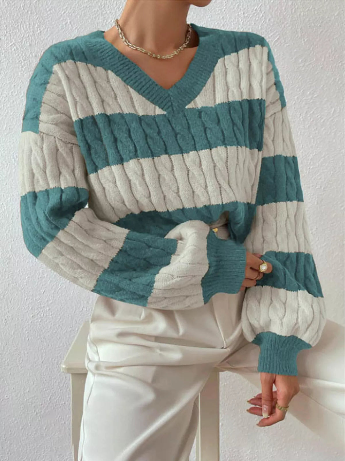 Teal and off-white striped cable knit V-neck sweater with long ribbed sleeves