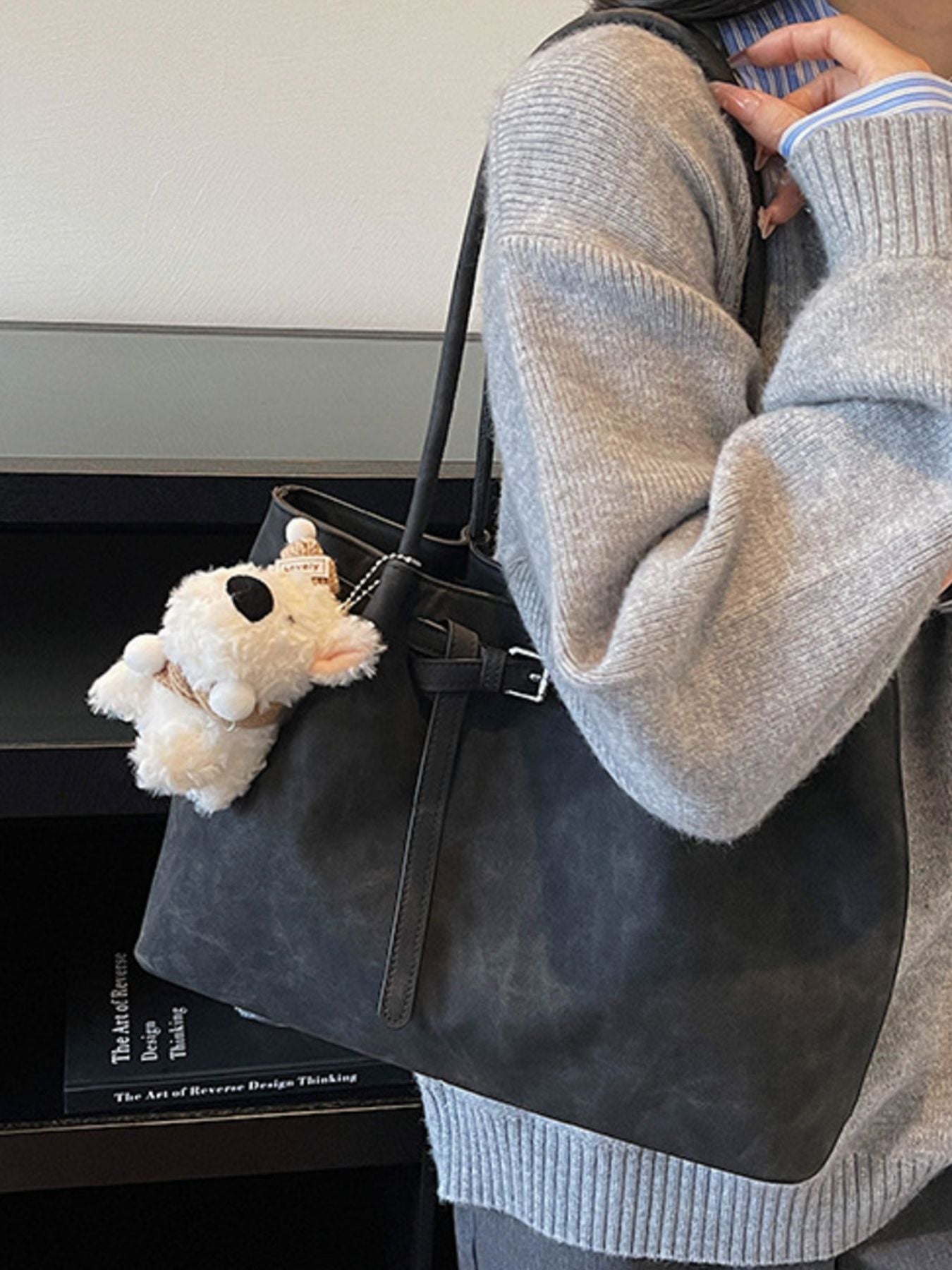 Buckle-detail shoulder bag in black PU, medium size, with plush teddy keychain