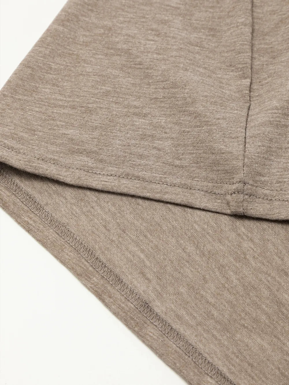 Mocha mini dress hem with visible stitching and seam detail