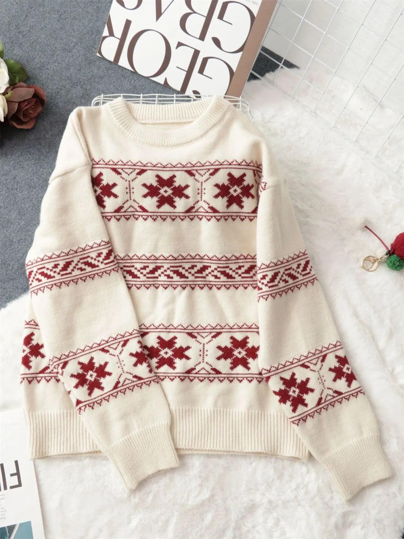 White Christmas-style knit sweater with red snowflake Fair Isle pattern and long sleeves