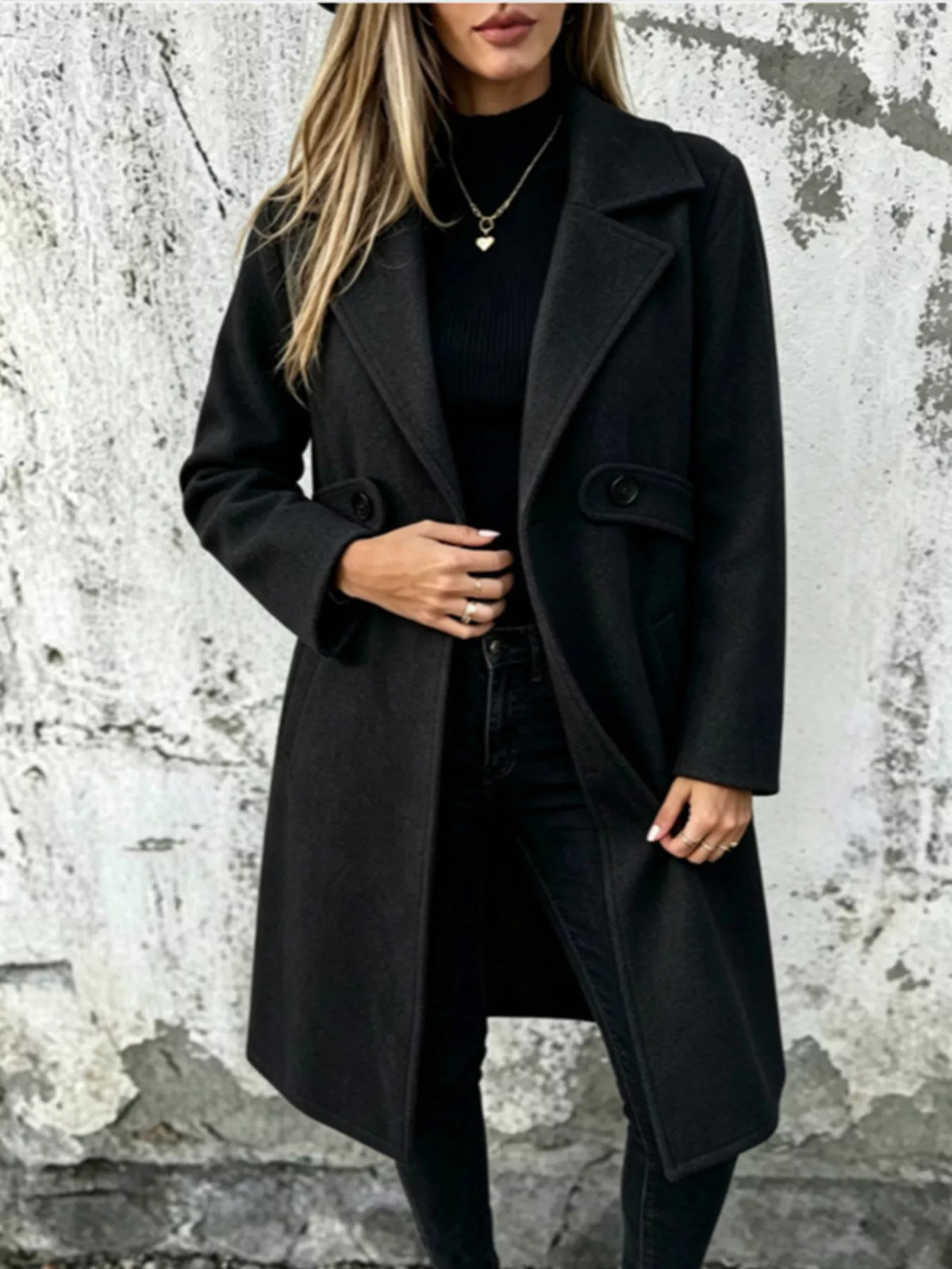 Black longline button-lapel coat with flap pockets and front buttons
