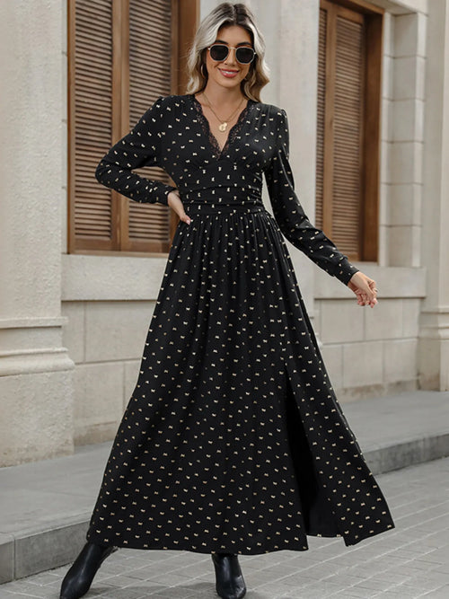 Black long sleeve V-neck maxi dress with small gold bow print and gathered waist