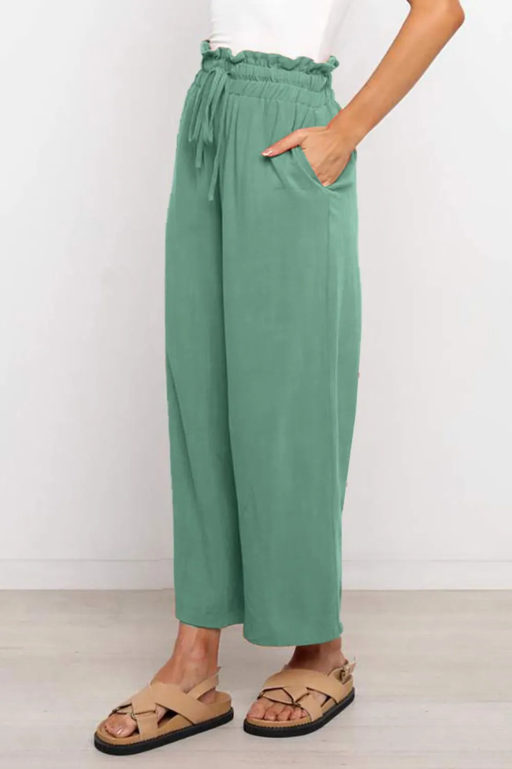 Green wide-leg pants with drawstring paperbag-style waist, relaxed fit to ankle