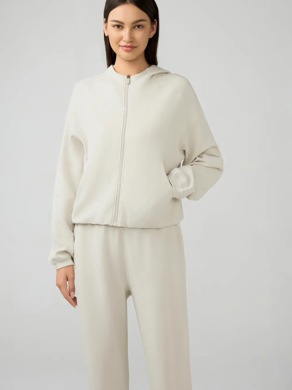 Cream zip-up hooded jacket with front zipper and relaxed dropped-shoulder fit