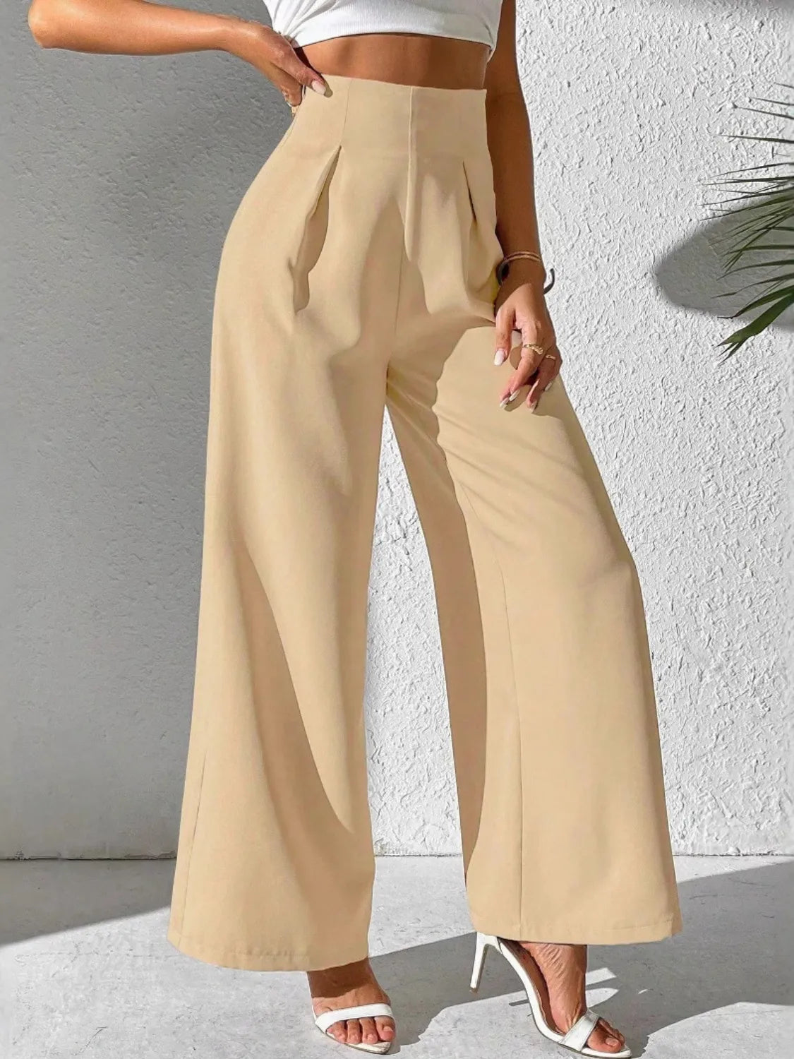 Beige high-waist wide-leg pants with pleats and relaxed fit