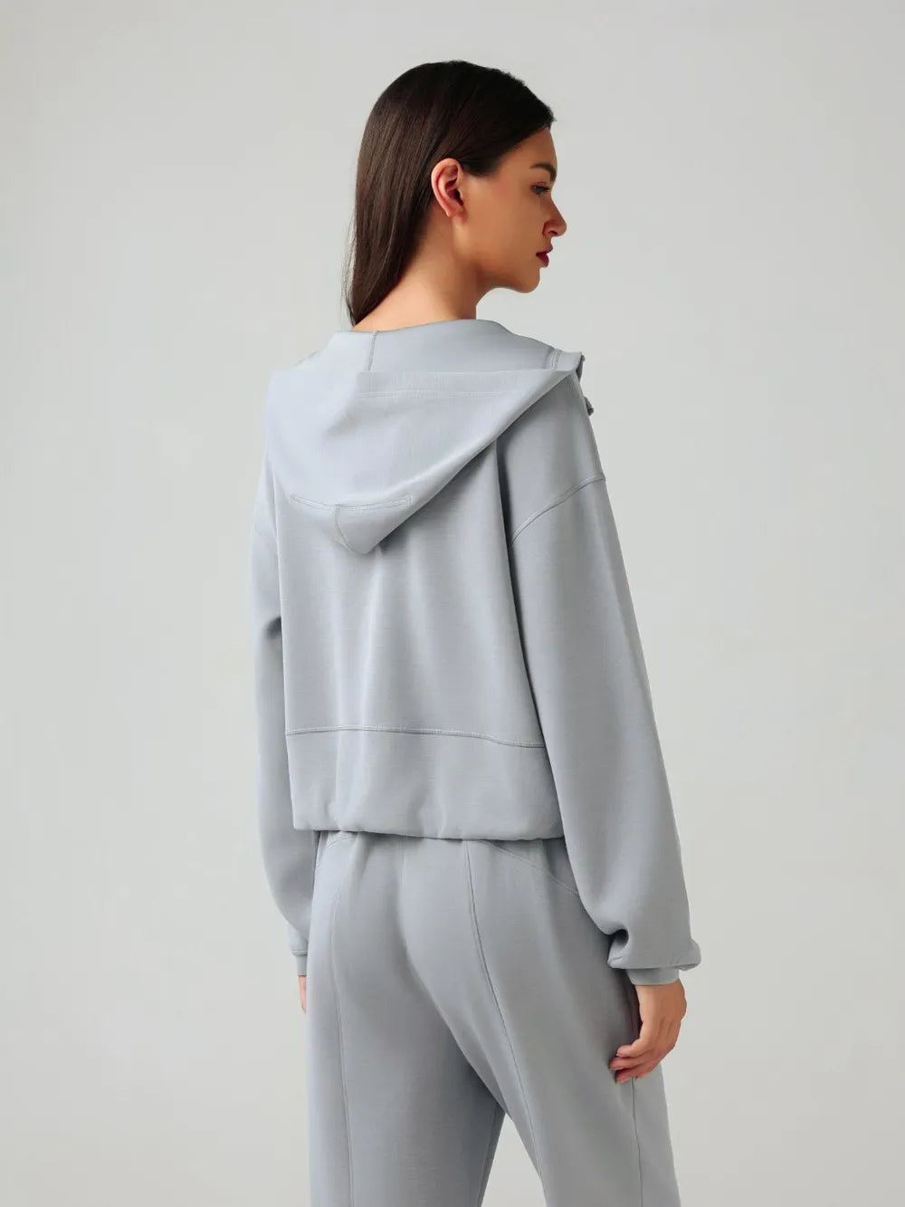 Light blue zip-up active hoodie back view with hood and full-length zipper seam