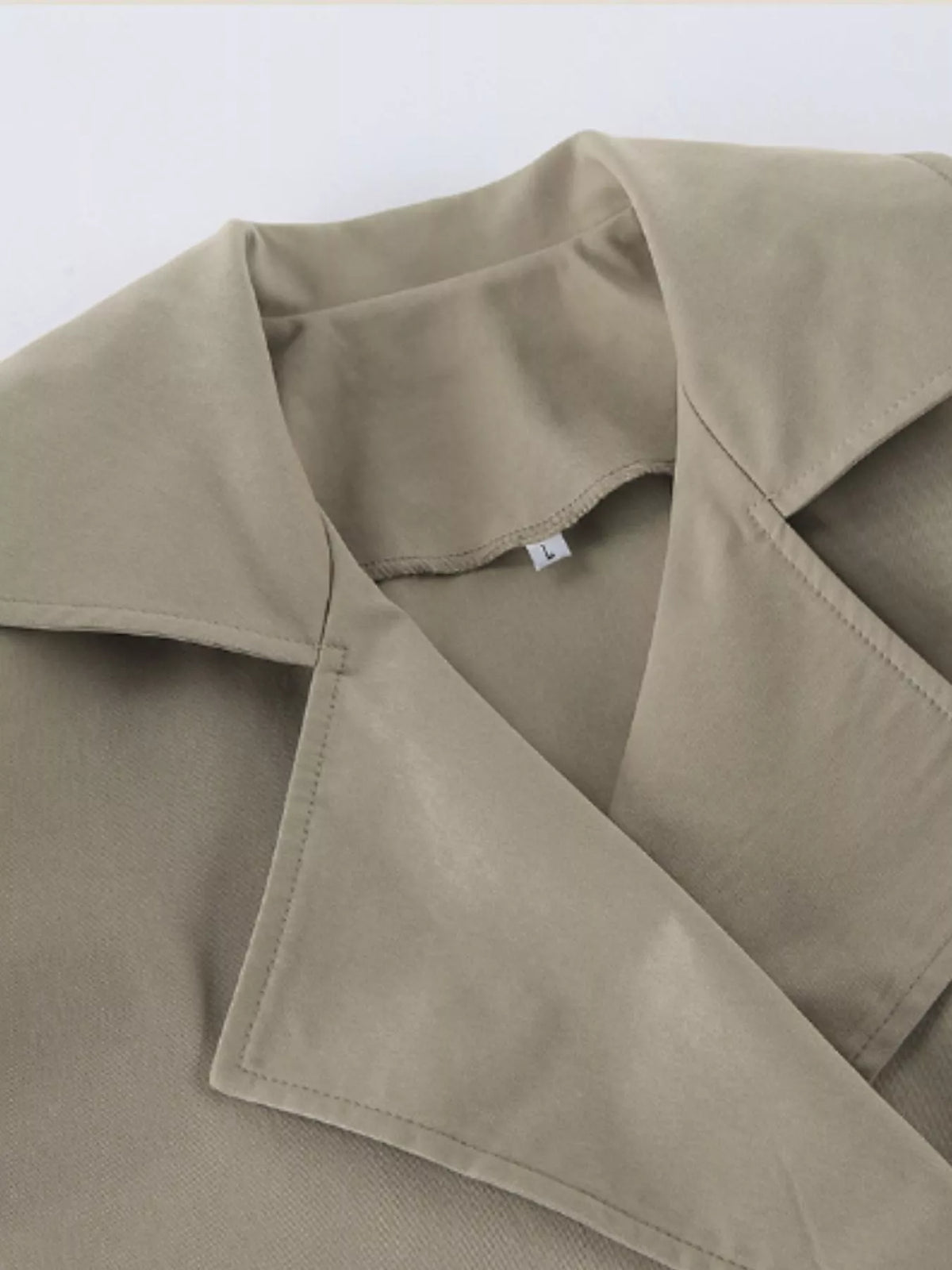 Khaki trench coat collar and lapel with visible inner placket seams