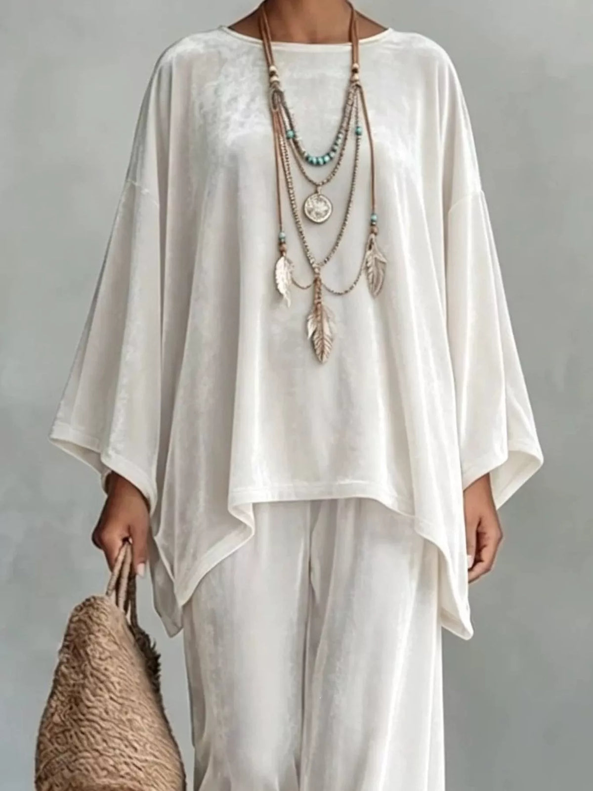 White velvet asymmetrical poncho top and matching wide-leg pants set