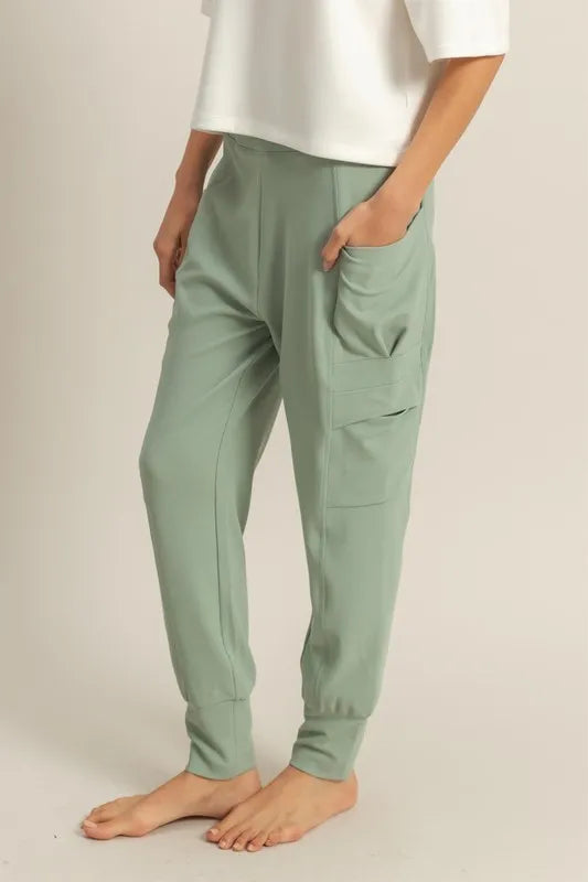 Sage green sweatpants with side pockets and elastic cuff ankle