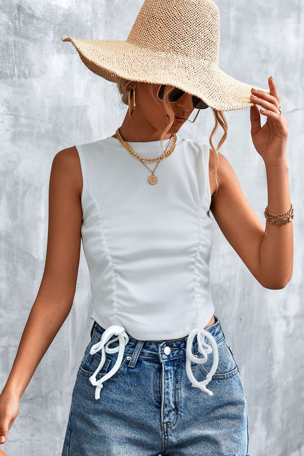 White sleeveless tank top with ruched front and drawstring tie hem