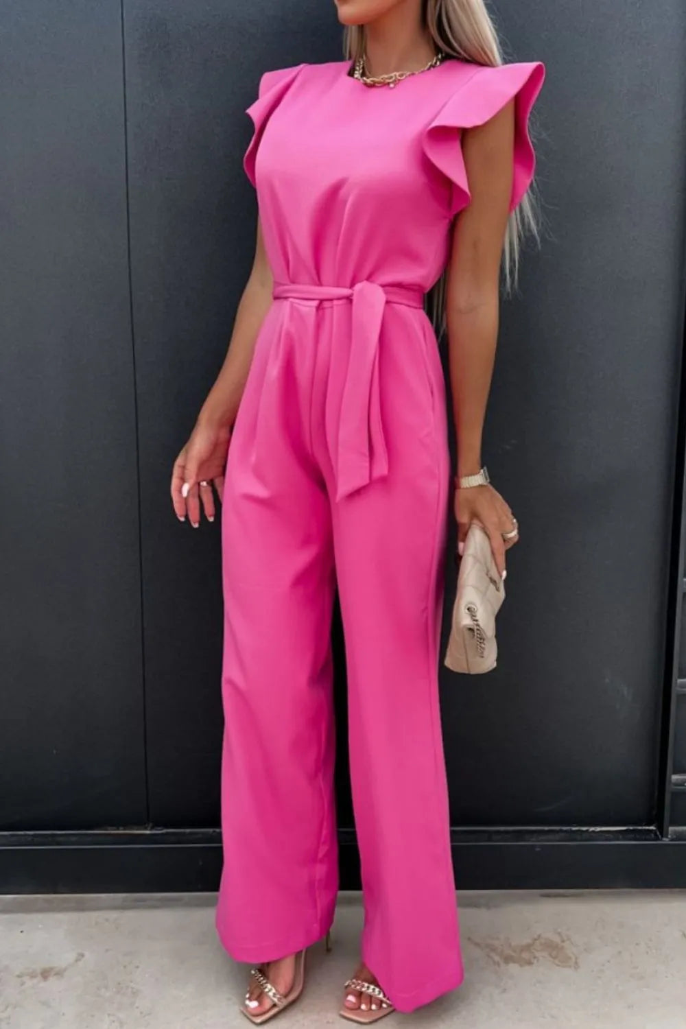Pink round-neck cap sleeve jumpsuit with wide legs and bow-tied waist