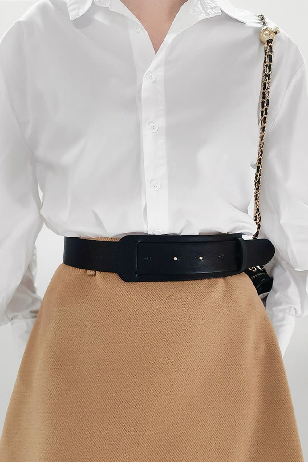 Vegan leather belt in dark color, wide strap with silver buckle holes and pin hardware