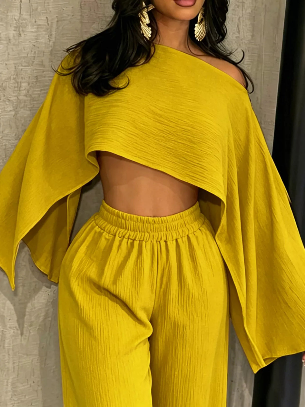 Yellow boat-neck crop top with wide sleeves and high-waist wide-leg pants