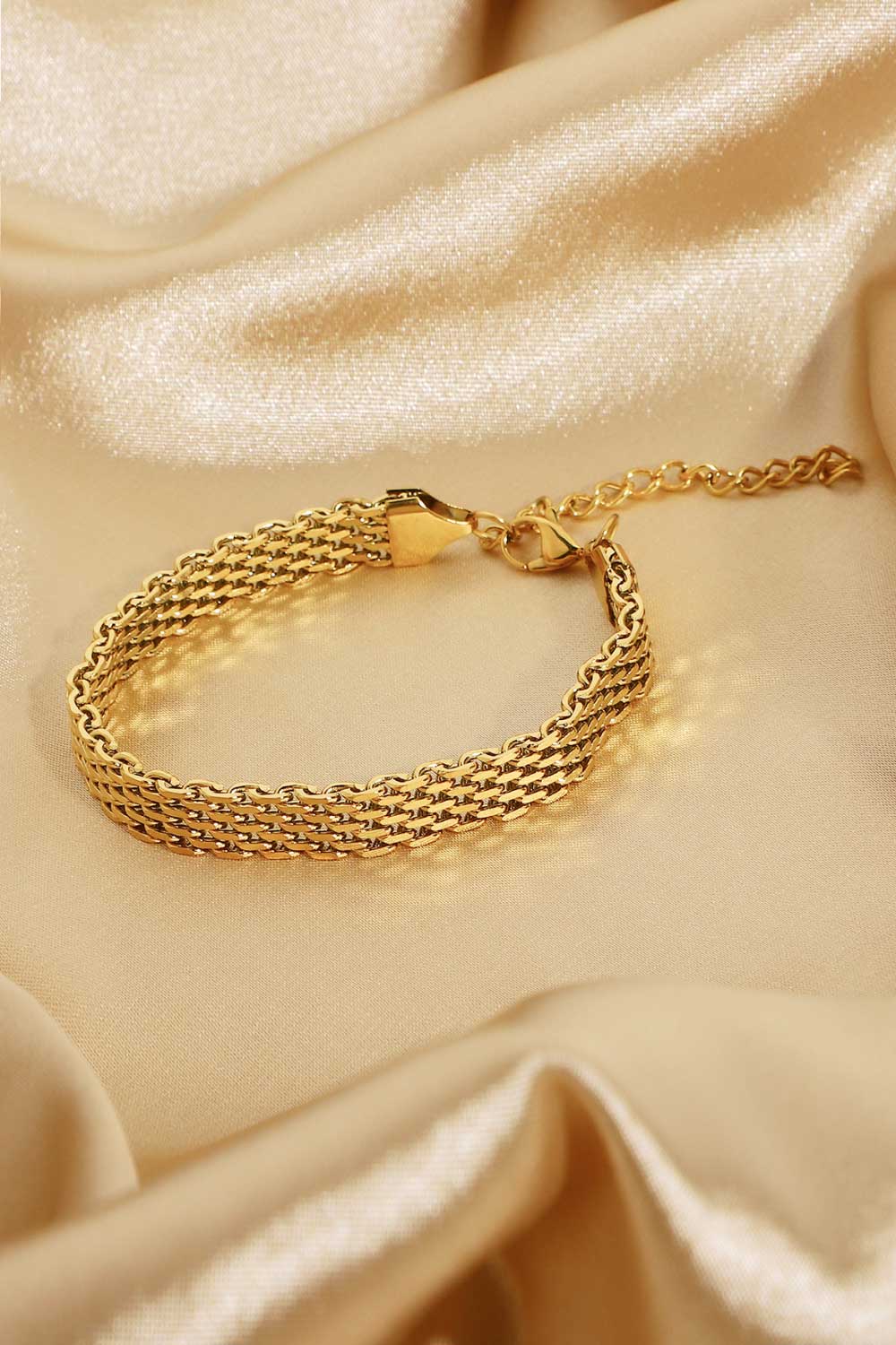 Gold-plated wide chain bracelet close-up of woven links and toggle clasp