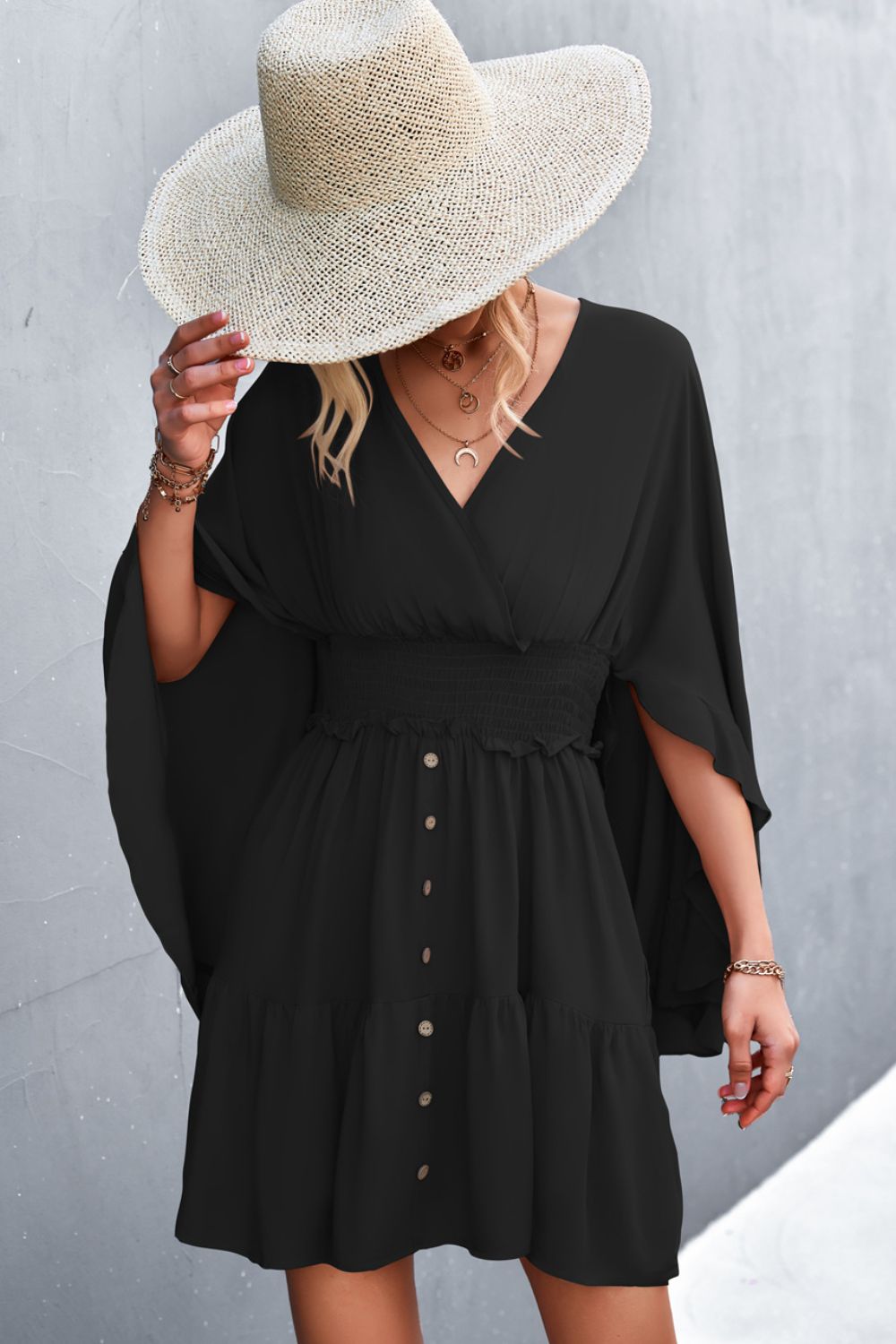 Black surplice dress with smocked waist and button-front detail, V neckline
