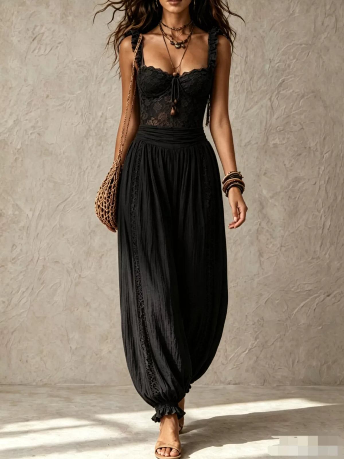 Black lace corset jumpsuit with ruffled straps and loose harem pant legs