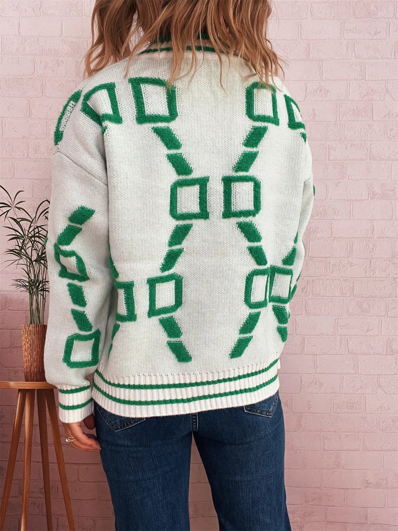 White round-neck long-sleeve sweater with green geometric pattern on back