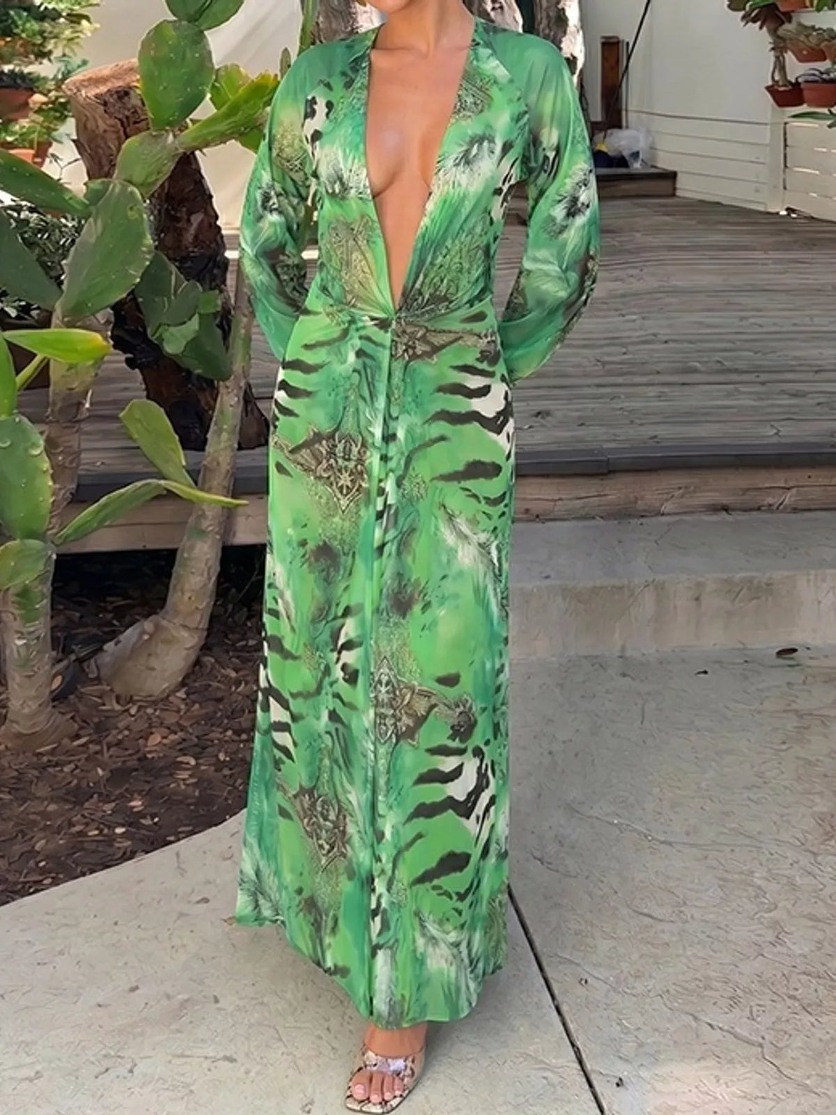 Green printed flowy maxi dress with deep V-neck, long sleeves, and gathered waist