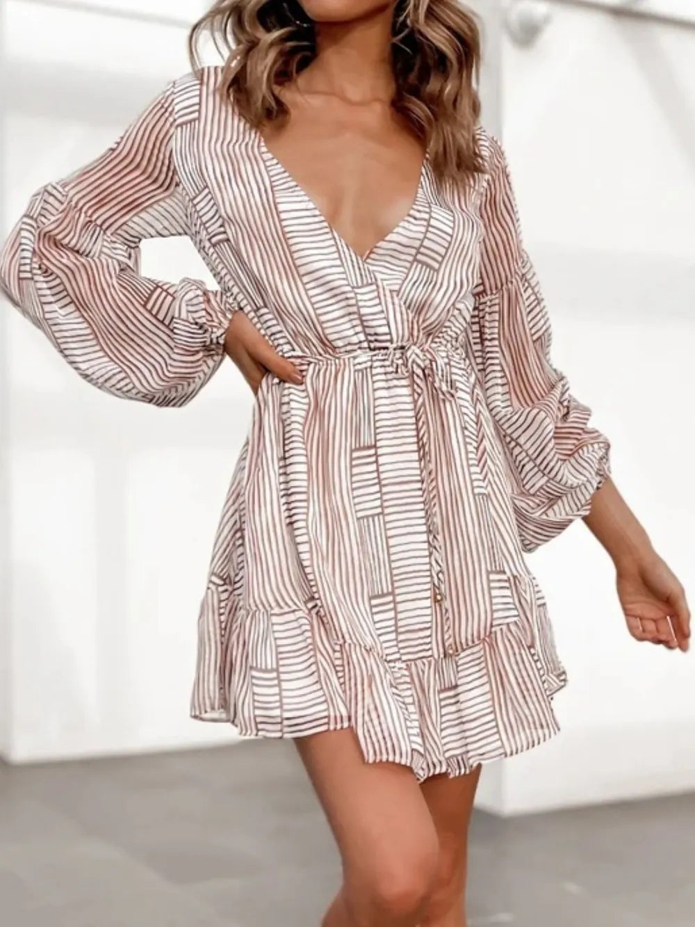 Camel-and-white striped long-sleeve surplice mini dress with V-neck and tiered skirt