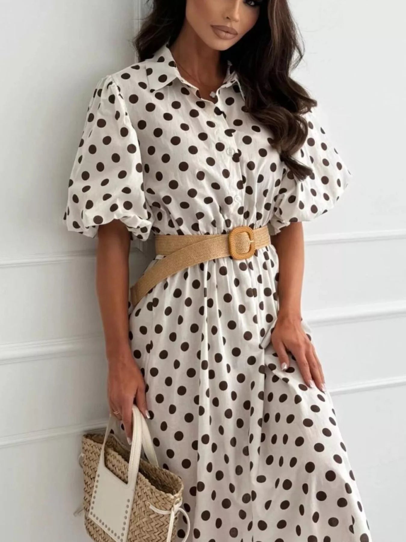White polka-dot puff-sleeve midi dress with button front and tan waist belt.