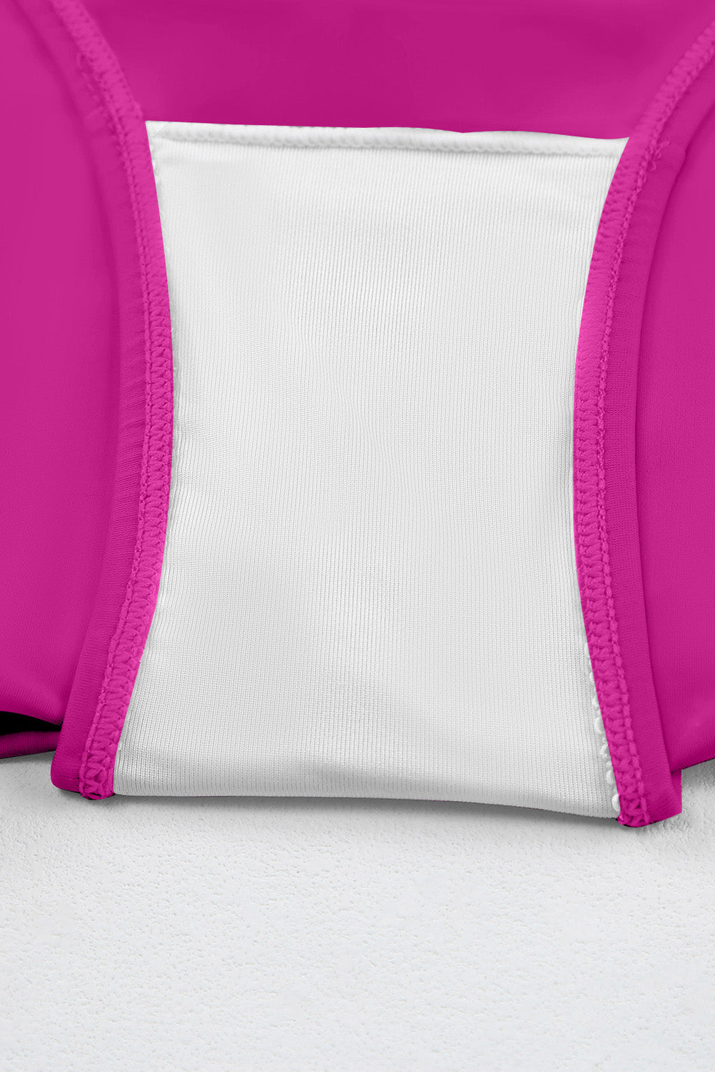 Ruched tankini top with white center panel and magenta side panels