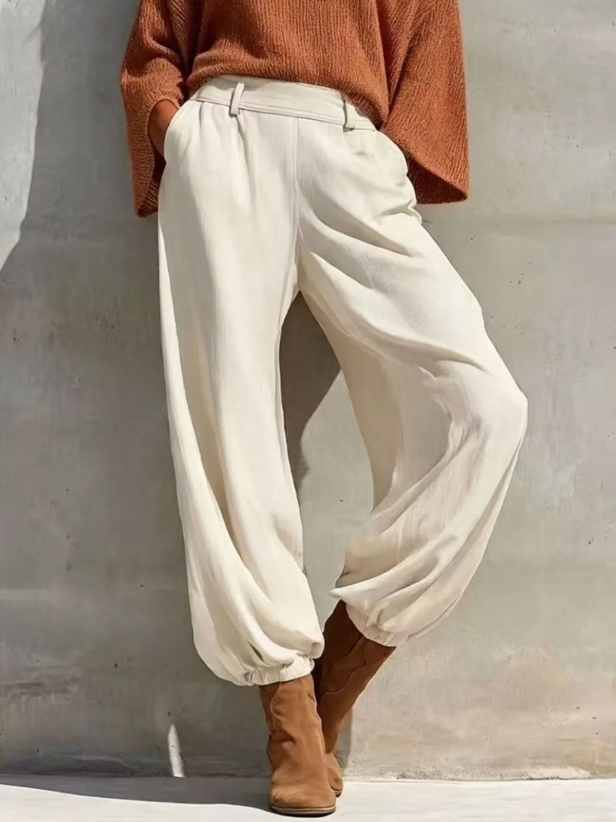 One-shoulder knit top and high-waisted pants set, rust top with white tapered pants