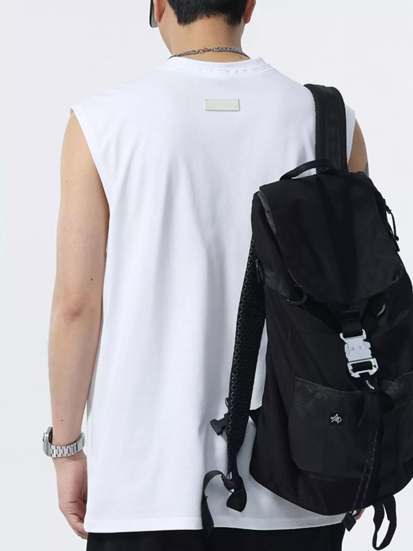 White sleeveless round-neck tank top, back view with neck label