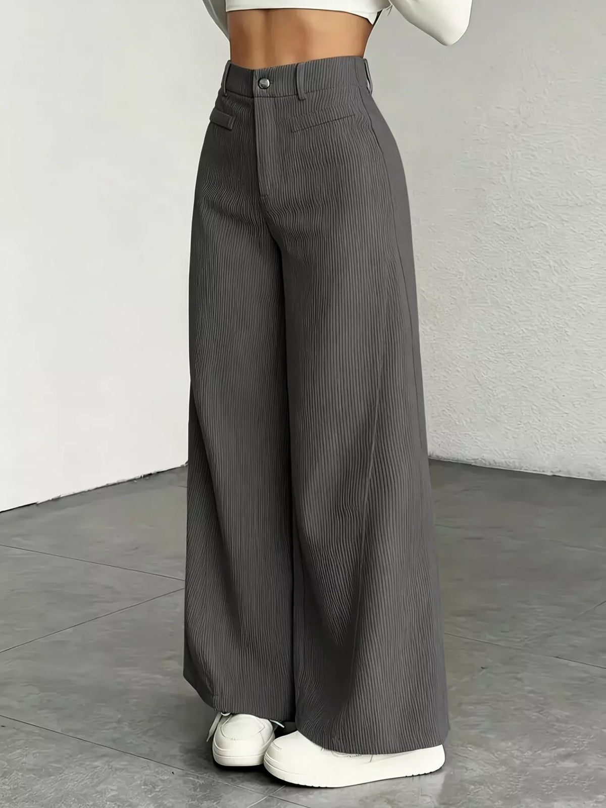 High-waisted wide-leg pants in charcoal gray with front pockets and button fly.
