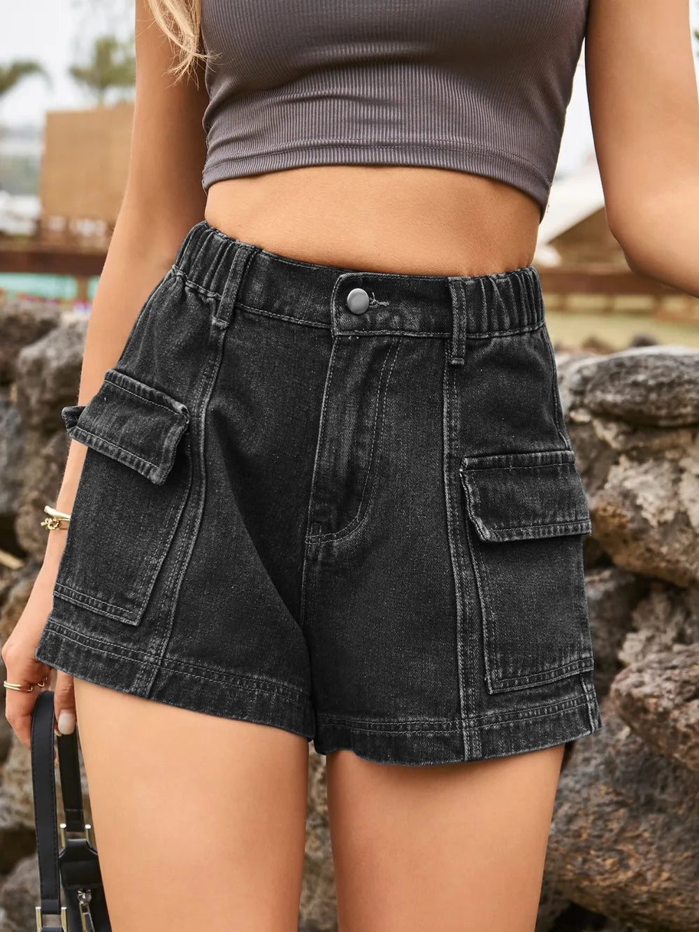 Black high-waist denim shorts with front button and flap patch pockets at sides