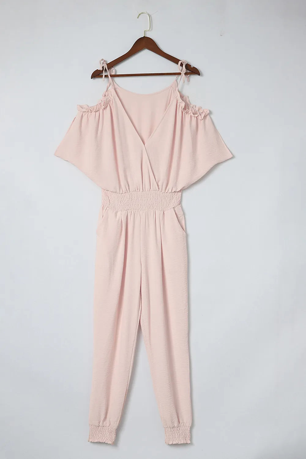 Pink cold-shoulder frill surplice jumpsuit on hanger, gathered waist and cuffed joggers