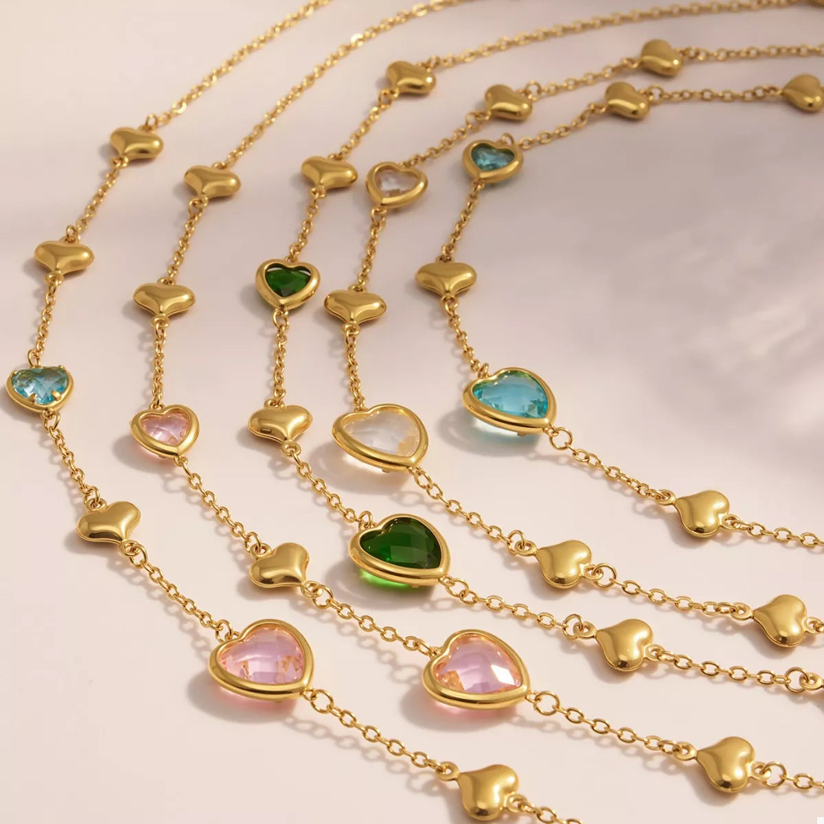 Gold-plated heart necklace set with pastel glass heart charms on linked chains