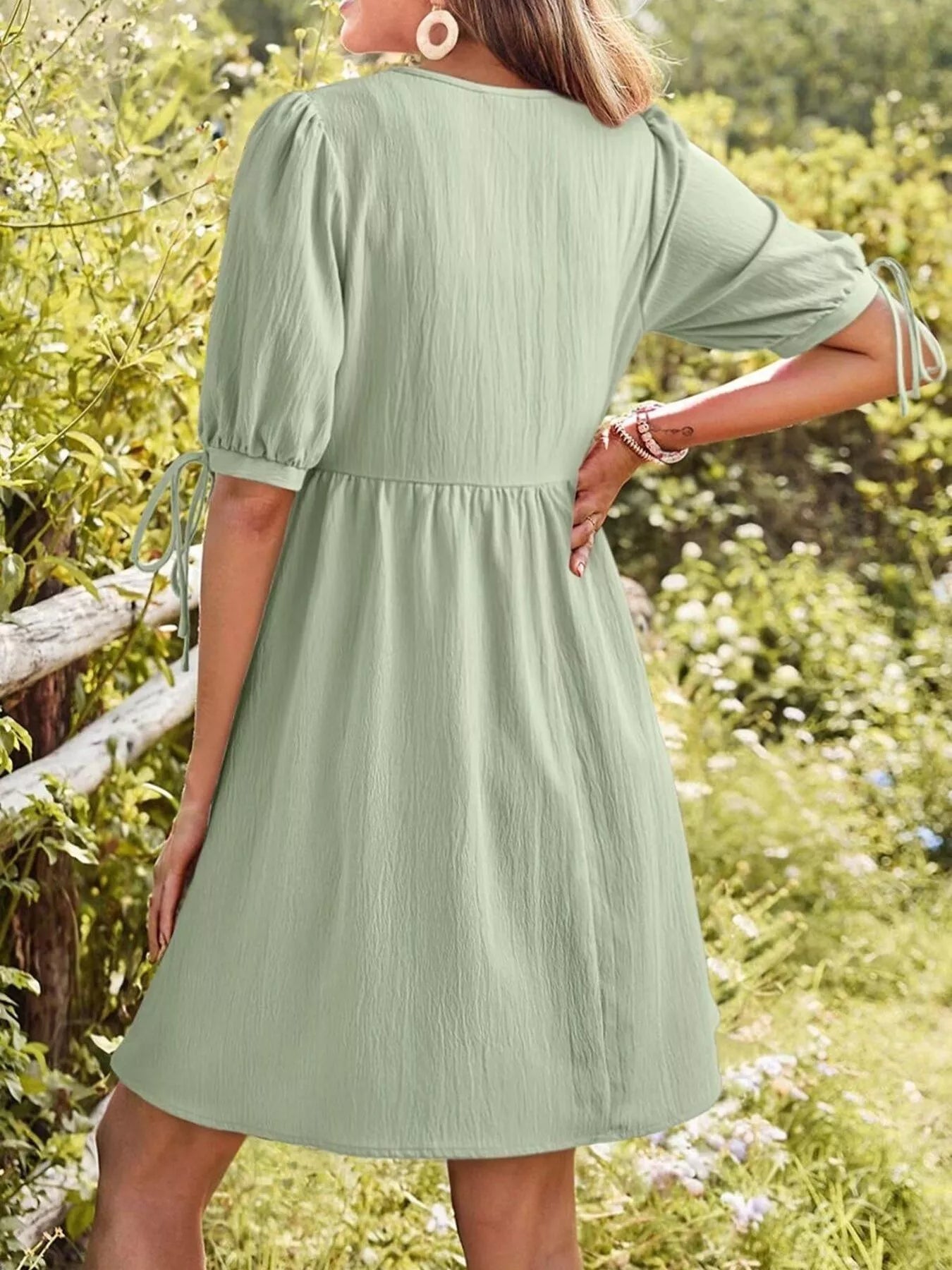 Tie-Neck Puff Sleeve A-Line Mini Dress in sage green, back view.