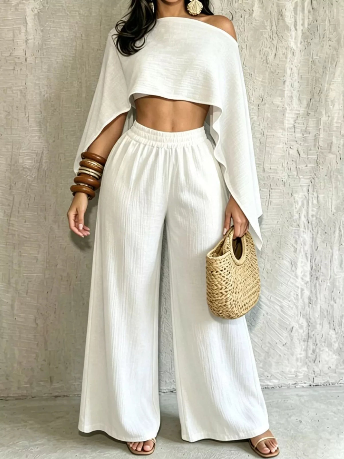 White boat-neck crop top and wide-leg pants set with draped sleeves and elastic waistband