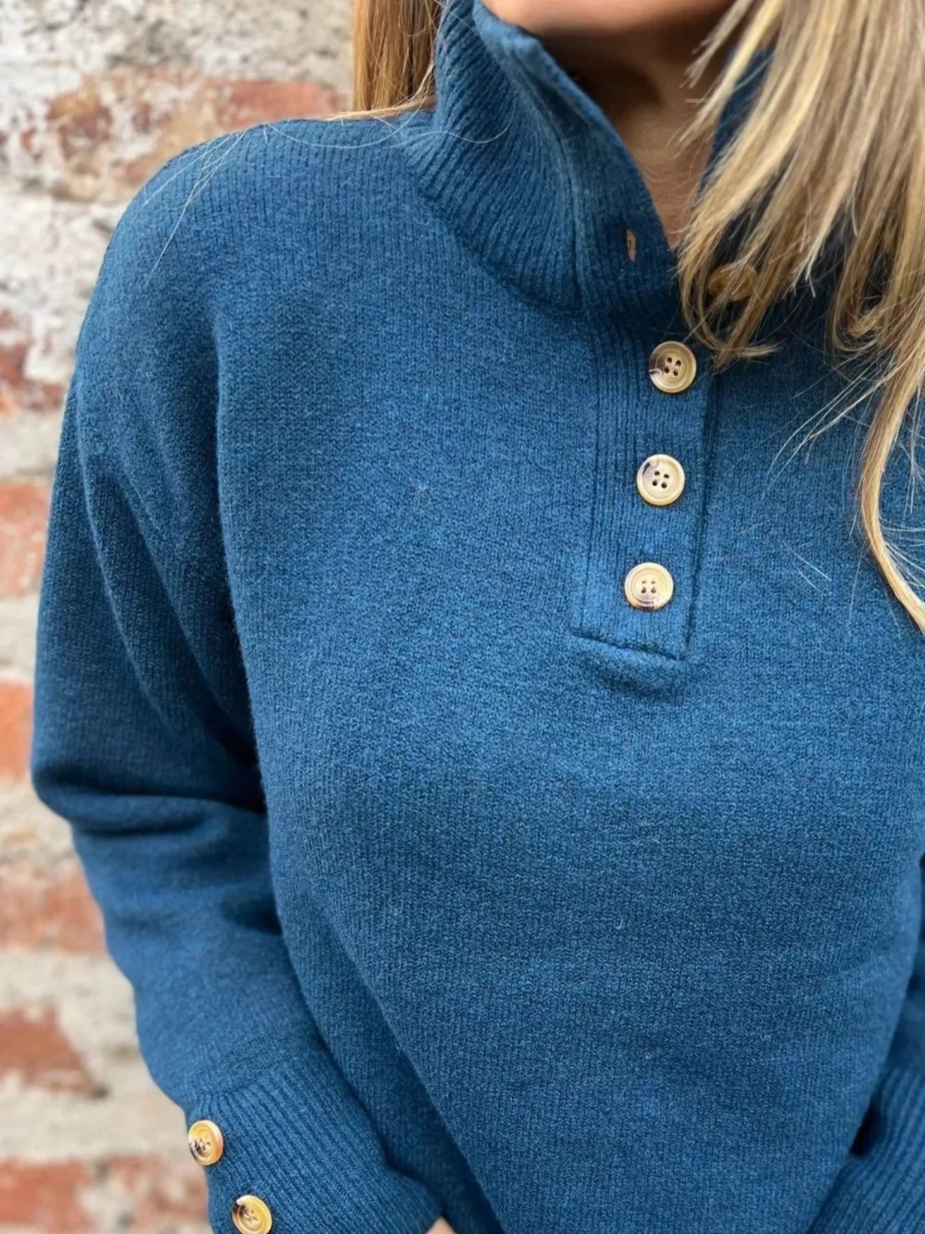 Blue knit turtleneck sweater with wooden-look button placket