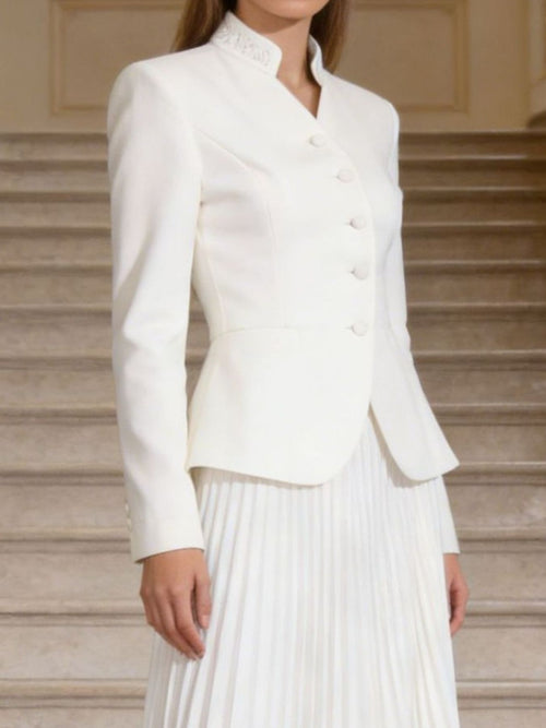 White long-sleeve button-up top with curved hem and pleated skirt set
