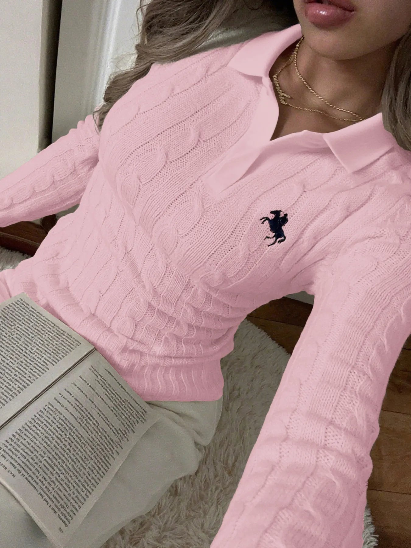 Pink cable-knit long-sleeve sweater with textured cable knit and horse logo