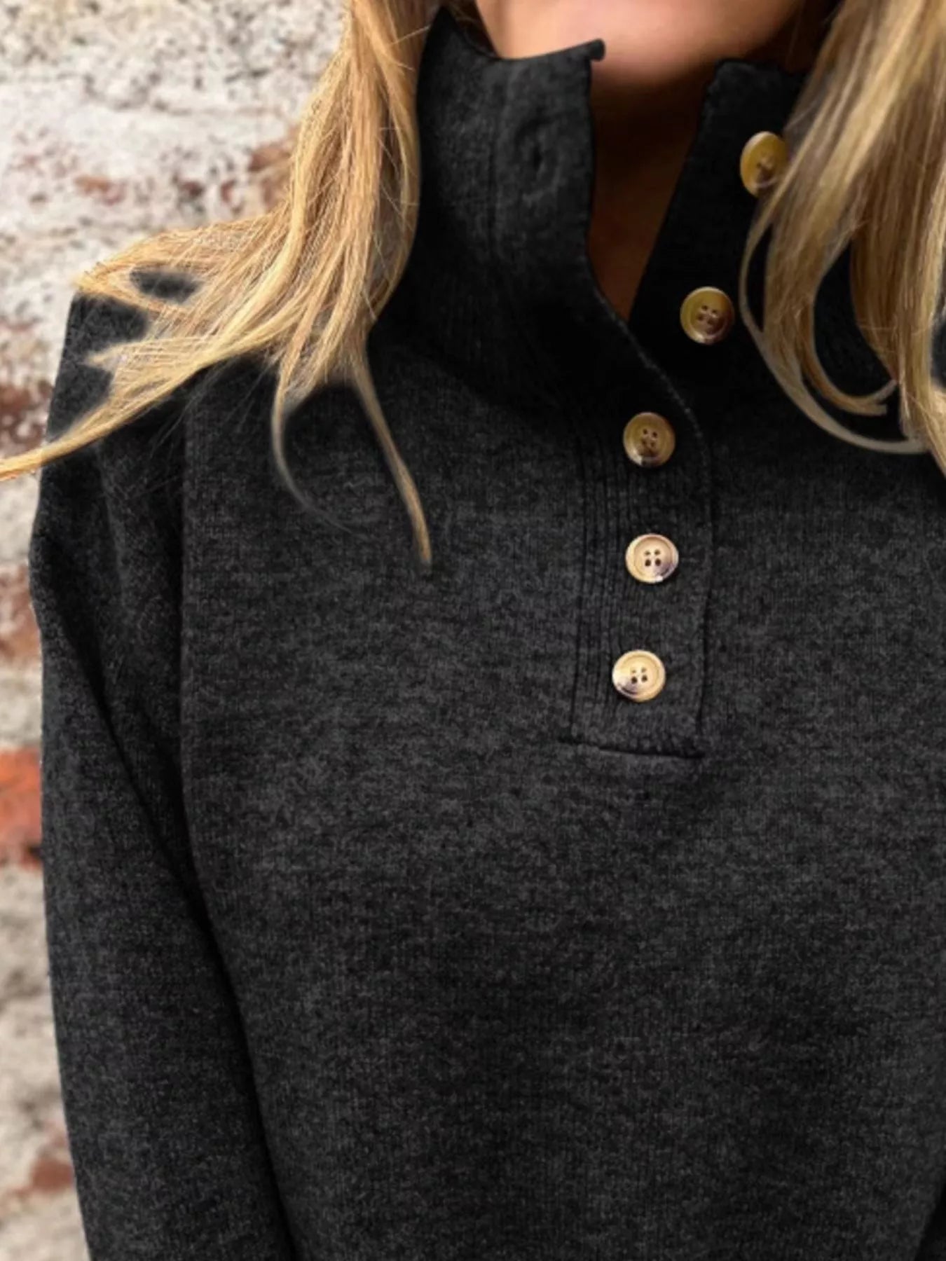 Black turtleneck sweater with button placket and wood-tone front buttons