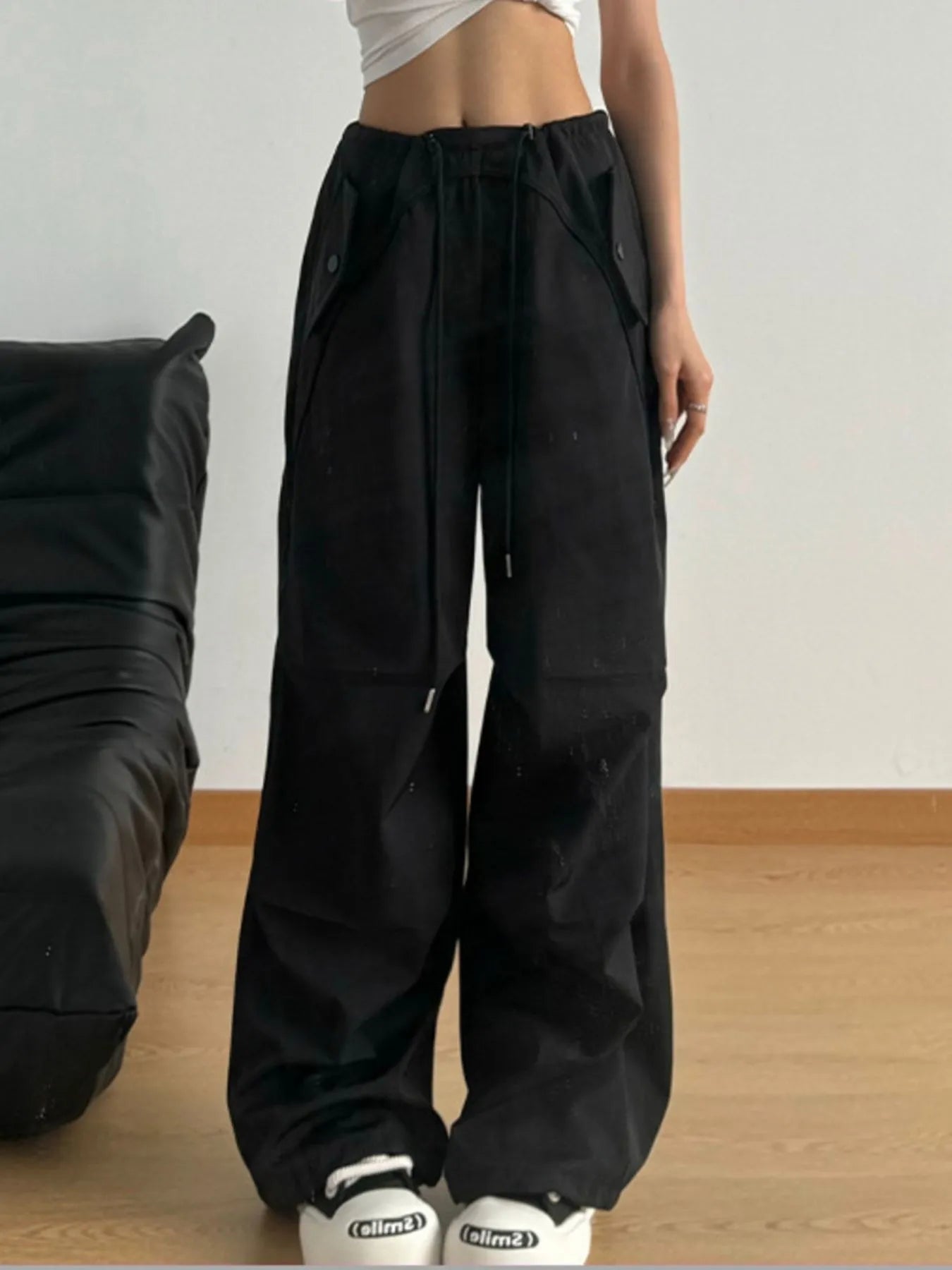 Black wide-leg drawstring pants with elastic waist and spacious straight legs