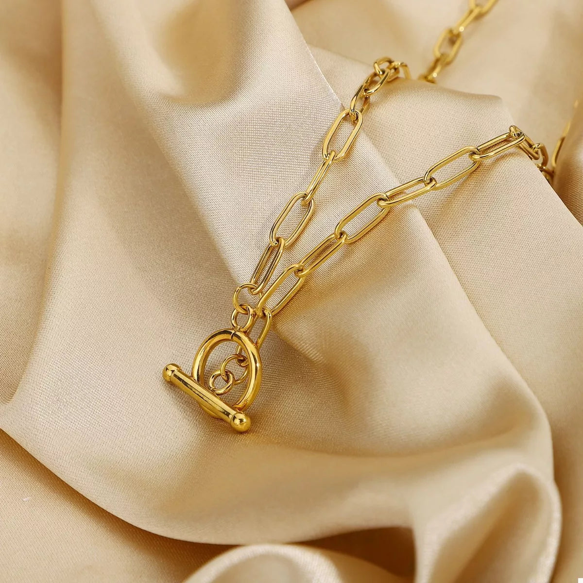 Gold chain link necklace with heart toggle clasp