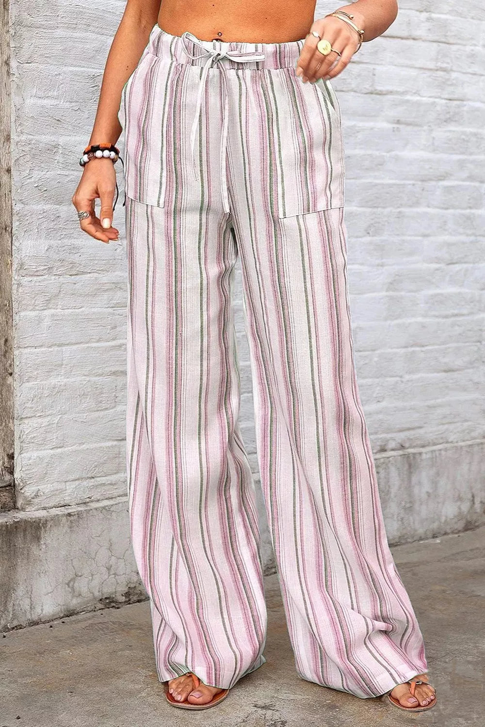 Dusty pink striped wide-leg pants with elastic waist, drawstring, and side pockets