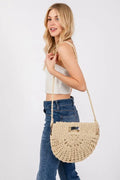 Braided semi-circle tote bag in ivory with shoulder strap, worn at side
