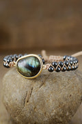 Black beaded bracelet featuring a round labradorite stone and gold-tone metal setting