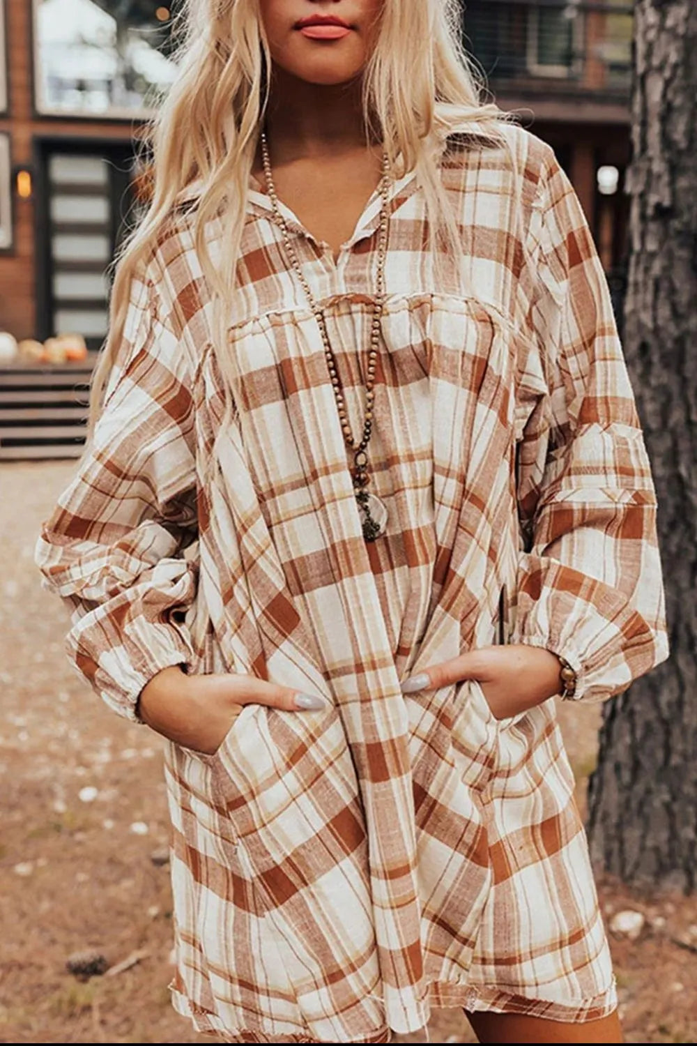 Plaid collared mini shirt dress close-up with button front and long sleeves