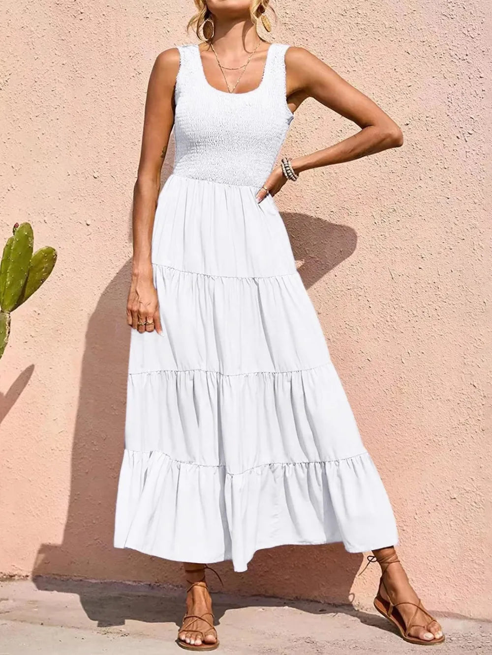 White tiered smocked wide-strap dress with sleeveless bodice and layered ruffle skirt.