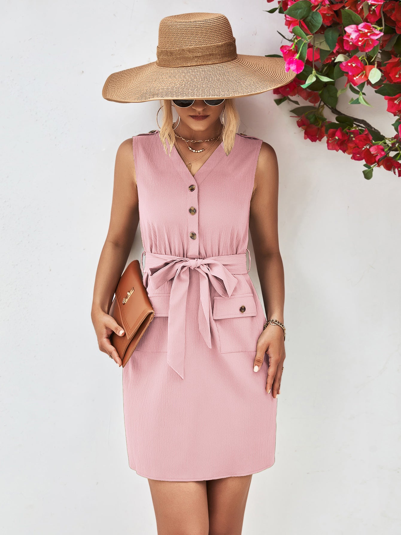 Blush pink sleeveless V-neck button dress with tied waist belt and flap pockets