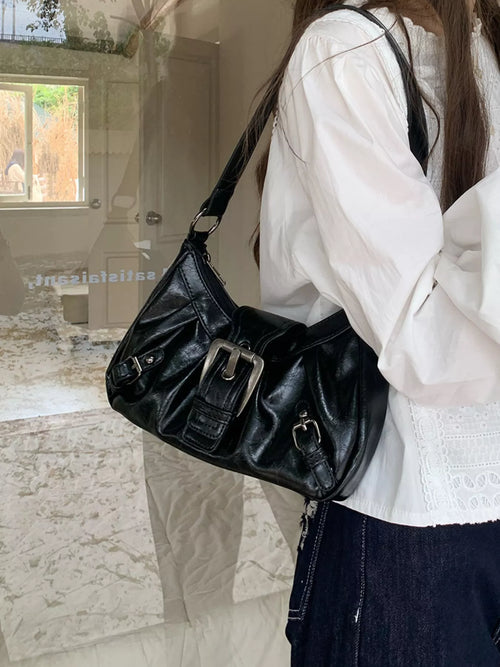 Black ruched shoulder bag with front buckle detail and adjustable shoulder strap