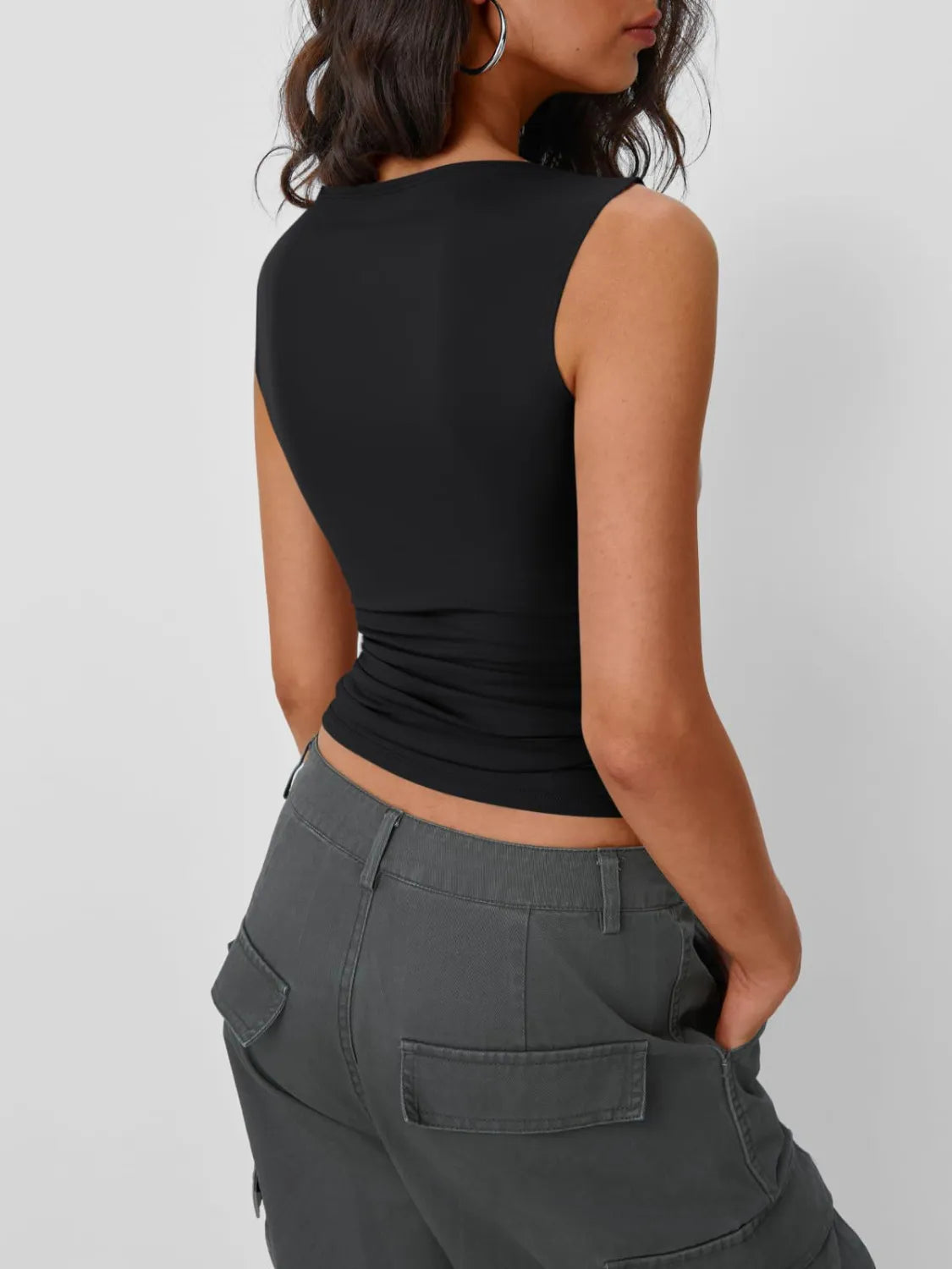 Black round neck sleeveless tank top with ruched hem at waist