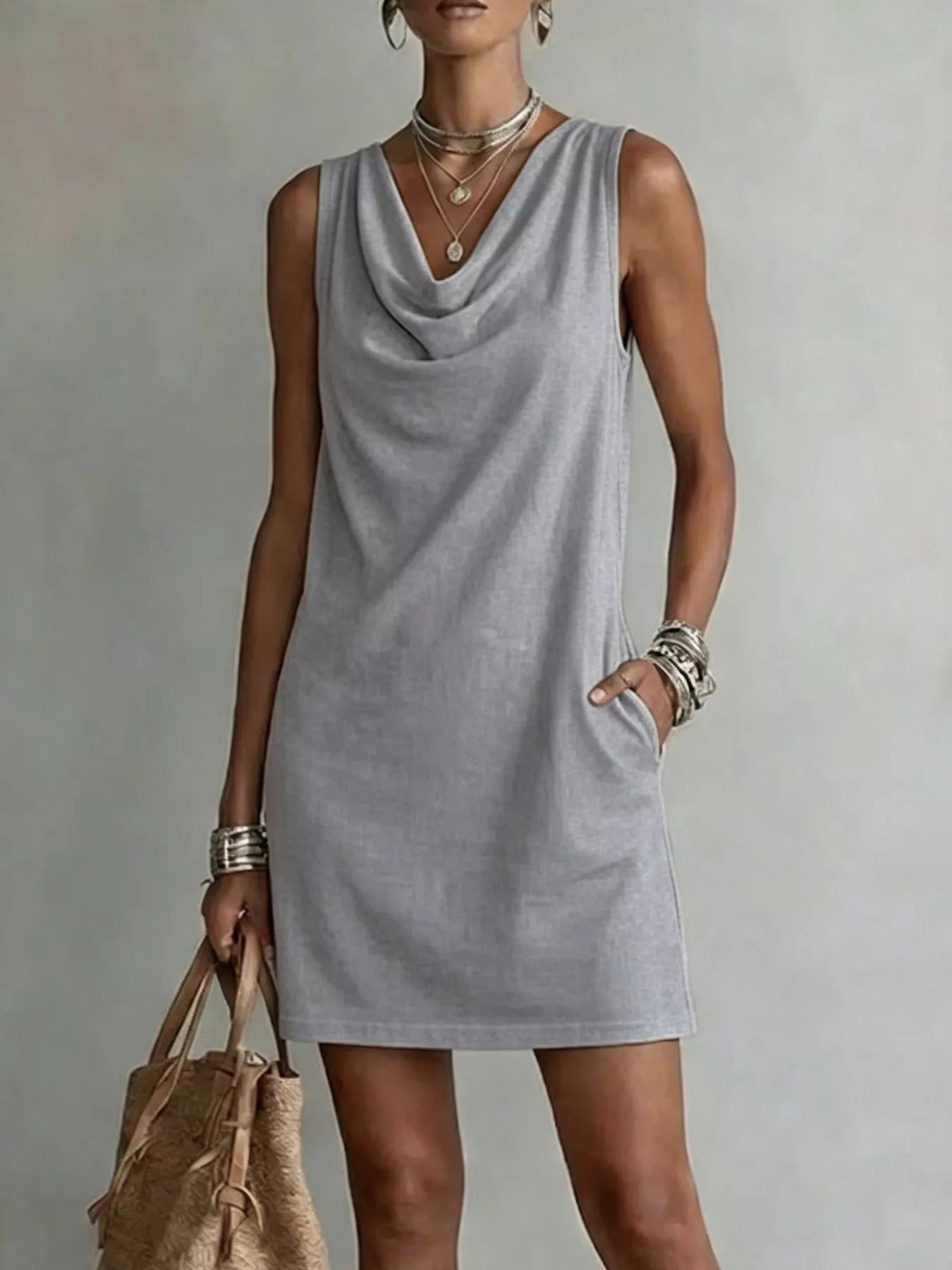 Gray sleeveless cowl-neck mini dress with draped neckline and straight hemline.