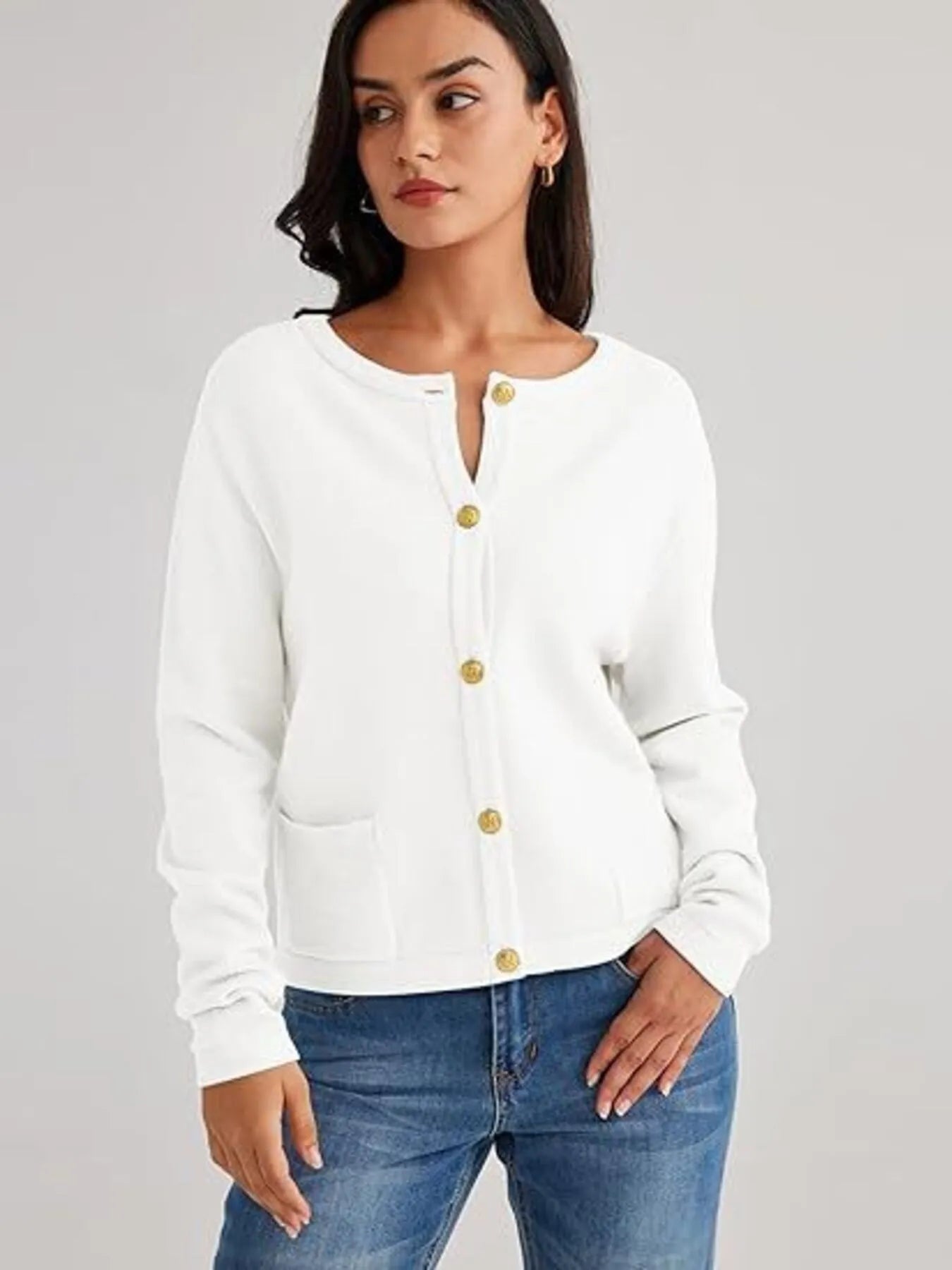 White button-up cardigan with long sleeves and gold snap-style buttons